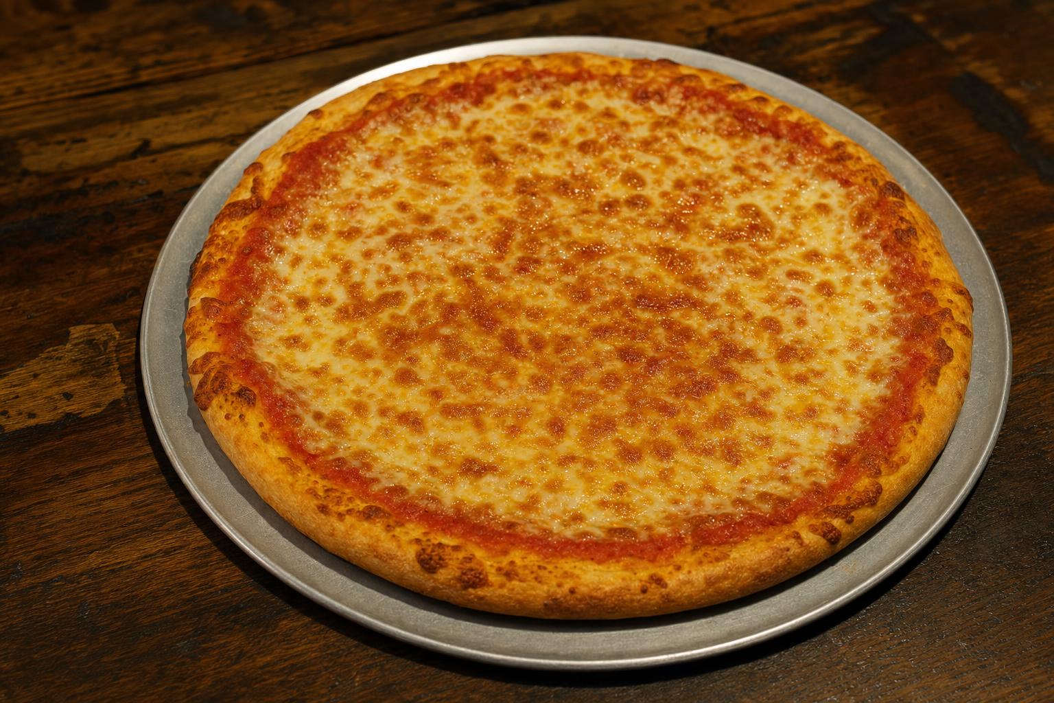 Cheese pizza with pizza sauce and mozzarella cheese on a warm wood table.